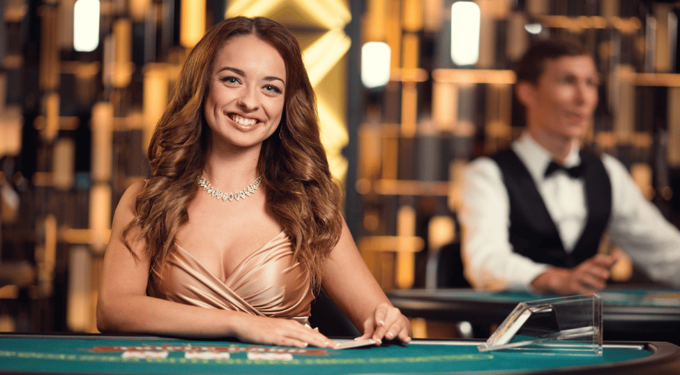 Female dealer dealing card at Triple Card Poker table by Evolution Gaming